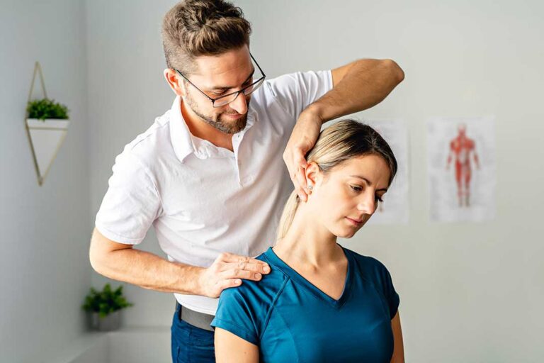 A chiropractor gently adjusting a patient's upper back in a quiet clinical room.